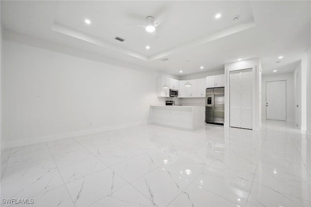 2401-2403 Quentin Ave S, Lehigh Acres, FL 33973 - unfurnished living room with a raised ceiling, recessed lighting, and light marble finish flooring