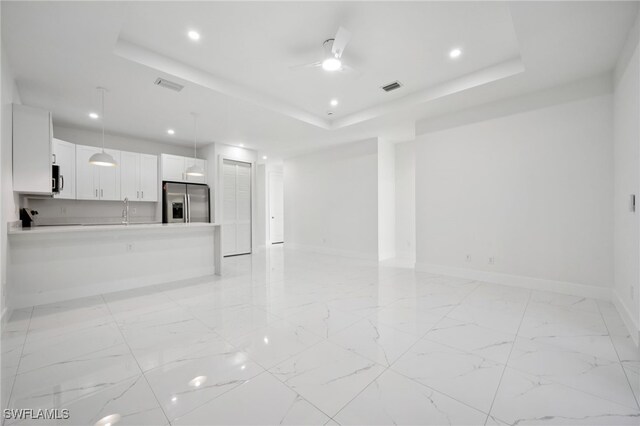 2401-2403 Quentin Ave S, Lehigh Acres, FL 33973 - unfurnished living room with a tray ceiling, recessed lighting, a ceiling fan, and light marble finish flooring