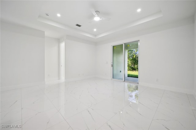 2401-2403 Quentin Ave S, Lehigh Acres, FL 33973 - spare room featuring a raised ceiling, light marble finish floors, and recessed lighting