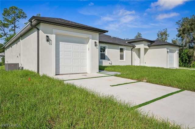 2401-2403 Quentin Ave S, Lehigh Acres, FL 33973 - view of front of property with an attached garage, driveway, stucco siding, and a front lawn