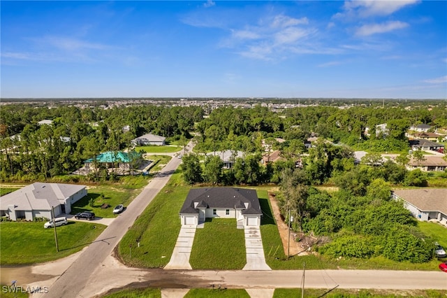 2401-2403 Quentin Ave S, Lehigh Acres, FL 33973 - aerial view of residential area featuring a tree filled landscape