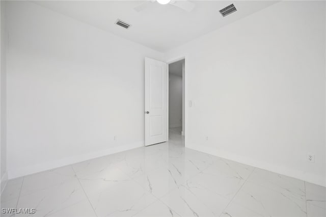 2401-2403 Quentin Ave S, Lehigh Acres, FL 33973 - empty room with light marble finish floors and ceiling fan