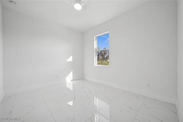 2401-2403 Quentin Ave S, Lehigh Acres, FL 33973 - empty room with light marble finish floors and a smoke detector