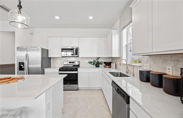 604 Oasis Lake Pl, Lehigh Acres, FL 33936 - kitchen with appliances with stainless steel finishes, white cabinets, decorative backsplash, pendant lighting, and recessed lighting