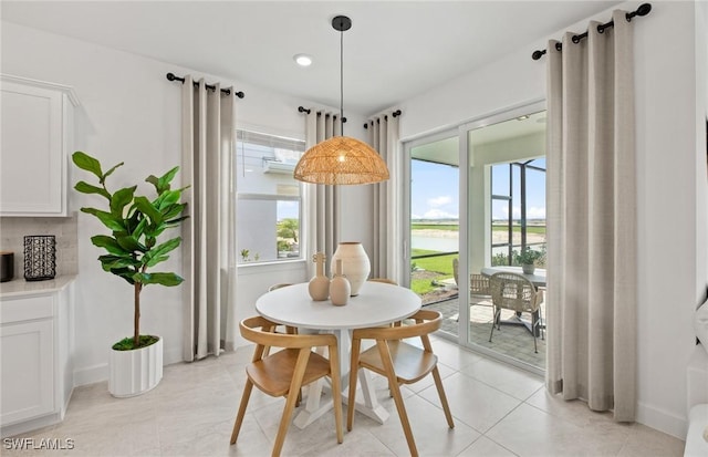 604 Oasis Lake Pl, Lehigh Acres, FL 33936 - dining room featuring a water view and light tile patterned flooring