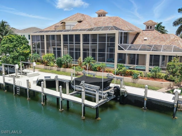 504 Tigertail Ct, Marco Island, FL 34145 - dock with boat lift, an outdoor pool, and a water view