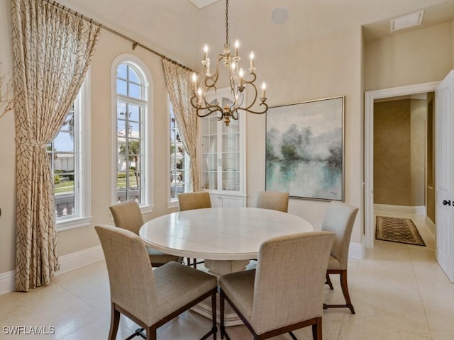 504 Tigertail Ct, Marco Island, FL 34145 - dining room featuring a chandelier and light tile patterned floors