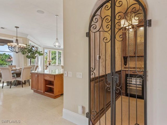 504 Tigertail Ct, Marco Island, FL 34145 - hallway with a chandelier and crown molding
