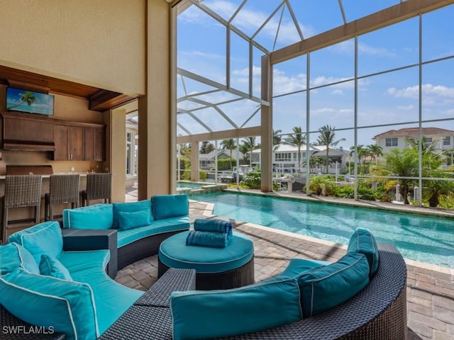 504 Tigertail Ct, Marco Island, FL 34145 - view of pool with a patio area, glass enclosure, an outdoor hangout area, a pool with connected hot tub, and exterior bar