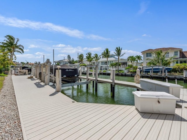 504 Tigertail Ct, Marco Island, FL 34145 - dock with boat lift, a water view, and a residential view