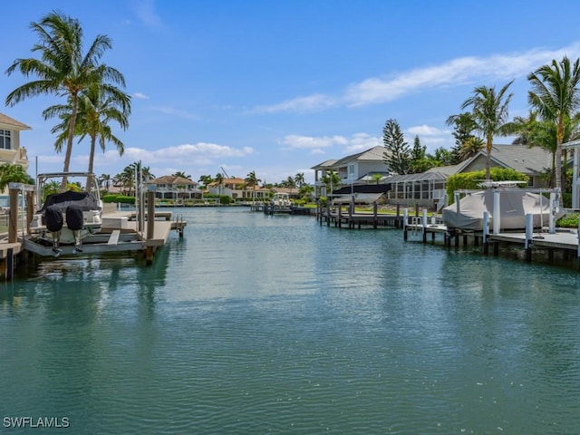 504 Tigertail Ct, Marco Island, FL 34145 - dock area with boat lift, a water view, and a residential view