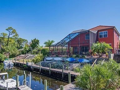 27329 Jolly Roger Ln, Bonita Springs, FL 34135 - dock area featuring a water view and a lanai