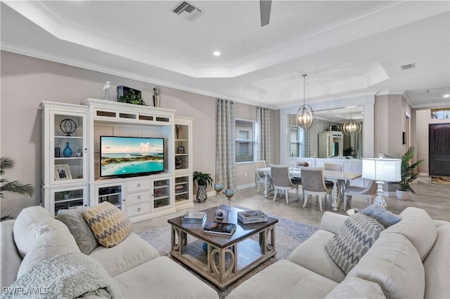 2786 Aviamar Cir, Naples, FL 34114 - living room with a tray ceiling, ornamental molding, a chandelier, recessed lighting, and a ceiling fan