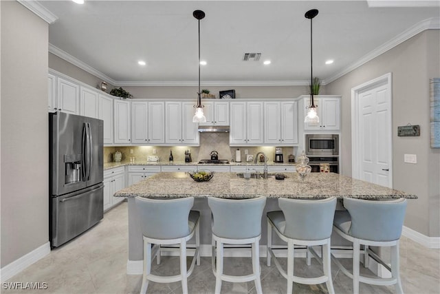 2786 Aviamar Cir, Naples, FL 34114 - kitchen featuring stainless steel appliances, under cabinet range hood, white cabinetry, a center island with sink, and tasteful backsplash