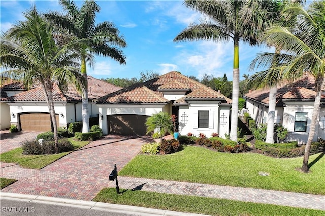 2786 Aviamar Cir, Naples, FL 34114 - mediterranean / spanish house with stucco siding, decorative driveway, an attached garage, and a front lawn