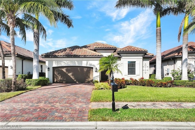 2786 Aviamar Cir, Naples, FL 34114 - mediterranean / spanish home featuring a tiled roof, a garage, stucco siding, decorative driveway, and a front yard
