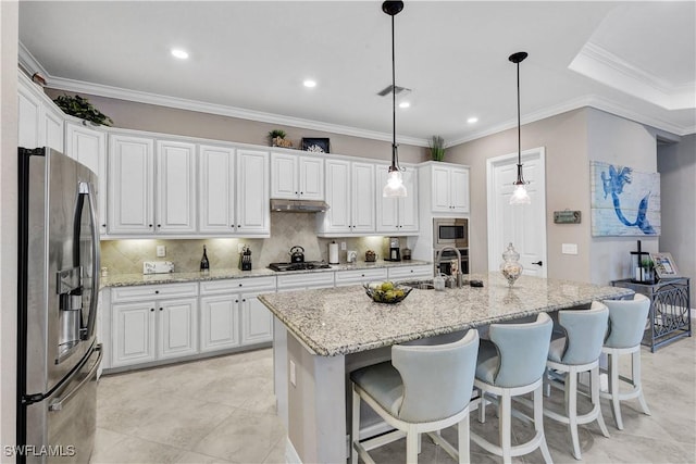 2786 Aviamar Cir, Naples, FL 34114 - kitchen with appliances with stainless steel finishes, white cabinetry, under cabinet range hood, a center island with sink, and backsplash