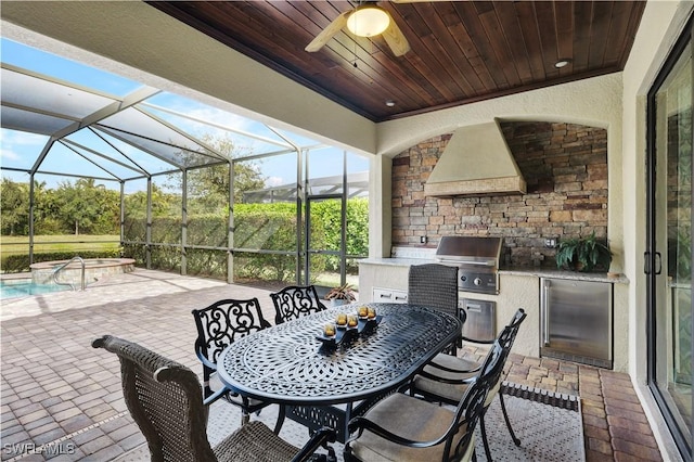 2786 Aviamar Cir, Naples, FL 34114 - view of patio / terrace with exterior kitchen, outdoor dining space, ceiling fan, and glass enclosure