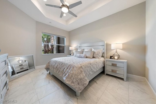 28646 Lobos Cir, Bonita Springs, FL 34135 - bedroom featuring light marble finish flooring, ceiling fan, and a tray ceiling