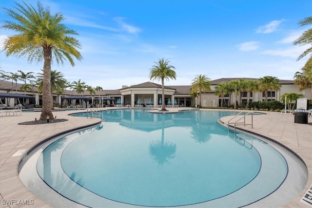 28646 Lobos Cir, Bonita Springs, FL 34135 - community pool featuring a patio