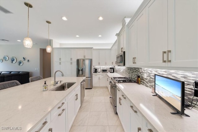28646 Lobos Cir, Bonita Springs, FL 34135 - kitchen with appliances with stainless steel finishes, open floor plan, tasteful backsplash, light stone counters, and recessed lighting