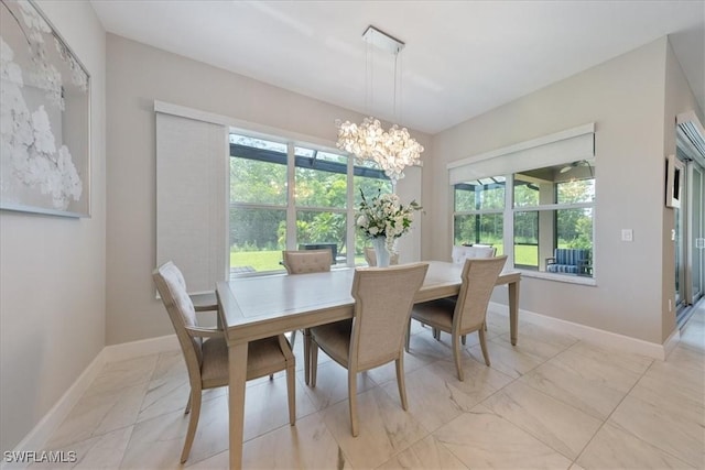 28646 Lobos Cir, Bonita Springs, FL 34135 - dining room with light marble finish floors, a chandelier, and healthy amount of natural light