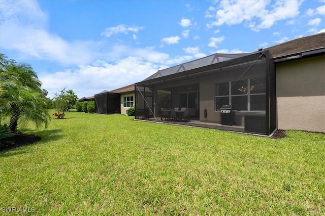 28646 Lobos Cir, Bonita Springs, FL 34135 - view of green lawn with glass enclosure and a patio area
