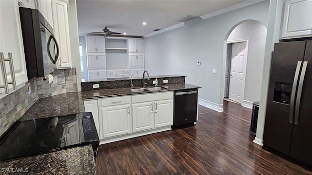 3940 Ruxton Rd, Naples, FL 34116 - kitchen featuring black appliances, a peninsula, arched walkways, ornamental molding, and dark wood-style floors