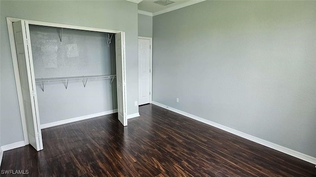 3940 Ruxton Rd, Naples, FL 34116 - unfurnished bedroom with crown molding, a closet, and wood finished floors