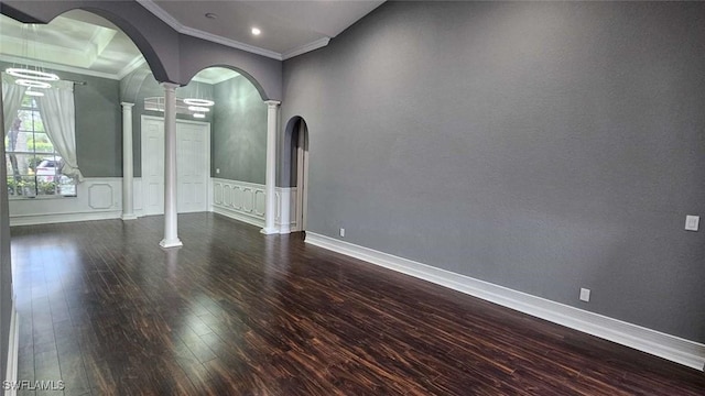 3940 Ruxton Rd, Naples, FL 34116 - spare room with ornate columns, arched walkways, hardwood / wood-style floors, ornamental molding, and a chandelier