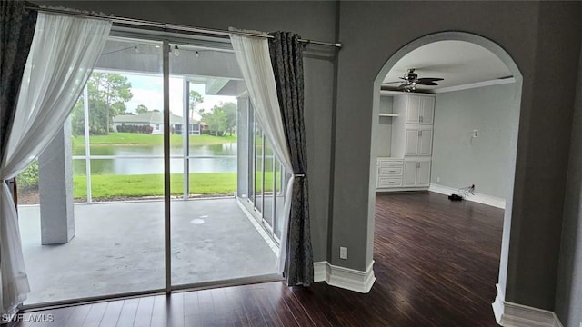 3940 Ruxton Rd, Naples, FL 34116 - doorway featuring a water view, a ceiling fan, wood finished floors, arched walkways, and crown molding
