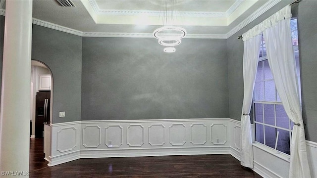 3940 Ruxton Rd, Naples, FL 34116 - spare room featuring dark wood finished floors, a raised ceiling, arched walkways, a chandelier, and crown molding