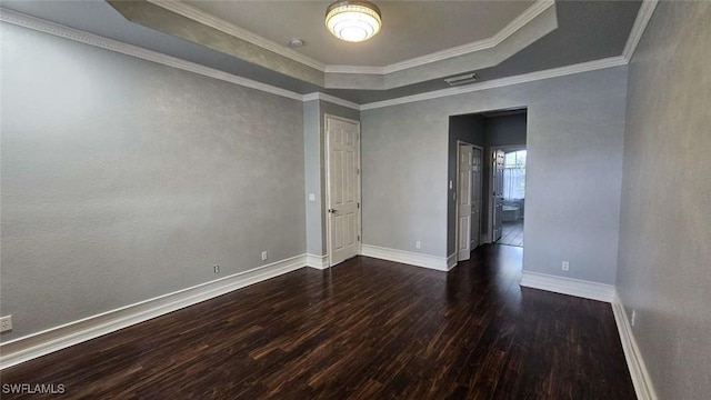 3940 Ruxton Rd, Naples, FL 34116 - empty room featuring dark wood-type flooring, a tray ceiling, and crown molding
