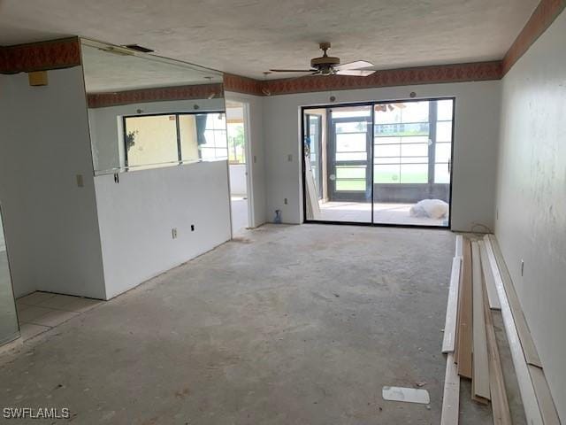 11060 Caravel Cir Unit 104, Fort Myers, FL 33908 - unfurnished living room featuring healthy amount of natural light, a ceiling fan, and unfinished concrete flooring