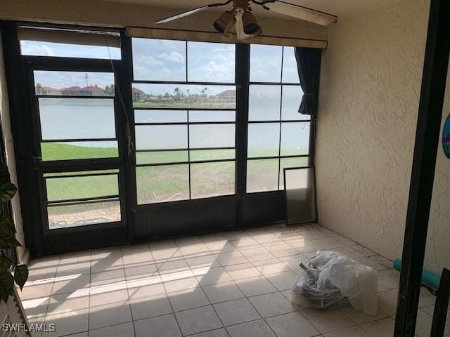 11060 Caravel Cir Unit 104, Fort Myers, FL 33908 - unfurnished sunroom with a water view, a ceiling fan, and healthy amount of natural light