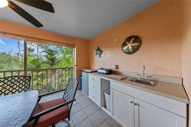2365 Bayou Ln Unit 10, Naples, FL 34112 - kitchen featuring white cabinetry, light countertops, light tile patterned flooring, a ceiling fan, and a textured wall