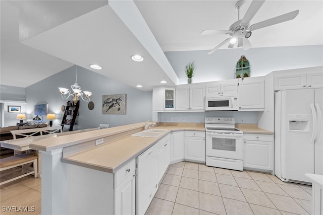 2365 Bayou Ln Unit 10, Naples, FL 34112 - kitchen featuring white appliances, a peninsula, light countertops, light tile patterned floors, and recessed lighting