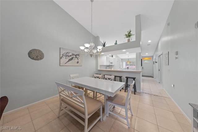 2365 Bayou Ln Unit 10, Naples, FL 34112 - dining space with light tile patterned floors, a chandelier, a towering ceiling, and recessed lighting