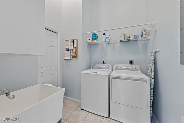 2365 Bayou Ln Unit 10, Naples, FL 34112 - laundry room featuring washer and clothes dryer and light tile patterned floors