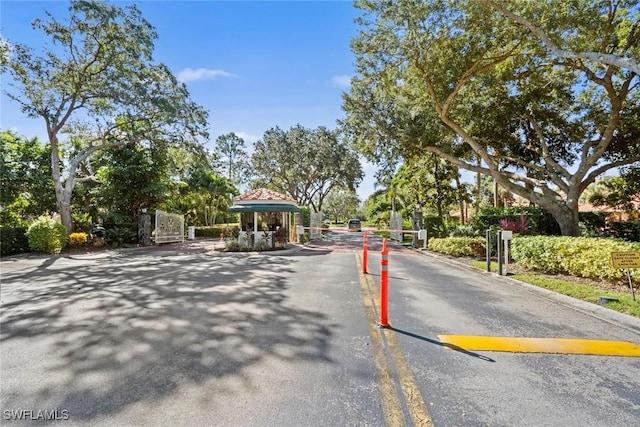 2365 Bayou Ln Unit 10, Naples, FL 34112 - view of asphalt street with a gated entry and curbs