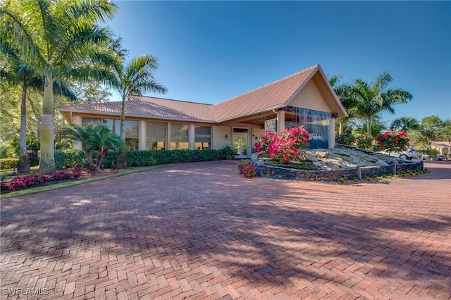 2365 Bayou Ln Unit 10, Naples, FL 34112 - single story home featuring french doors, a tile roof, and decorative driveway