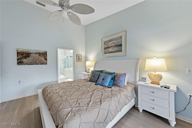 2365 Bayou Ln Unit 10, Naples, FL 34112 - bedroom featuring wood finished floors, ensuite bathroom, ceiling fan, and a high ceiling
