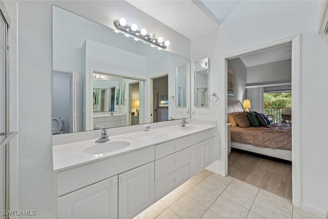 2365 Bayou Ln Unit 10, Naples, FL 34112 - ensuite bathroom with double vanity and tile patterned flooring