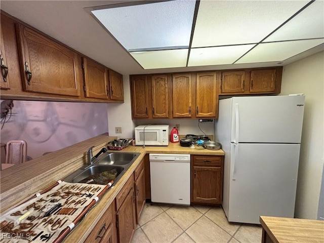 4265 Bay Beach Ln Unit 524, Fort Myers Beach, FL 33931 - kitchen featuring white appliances, brown cabinets, light countertops, and light tile patterned floors