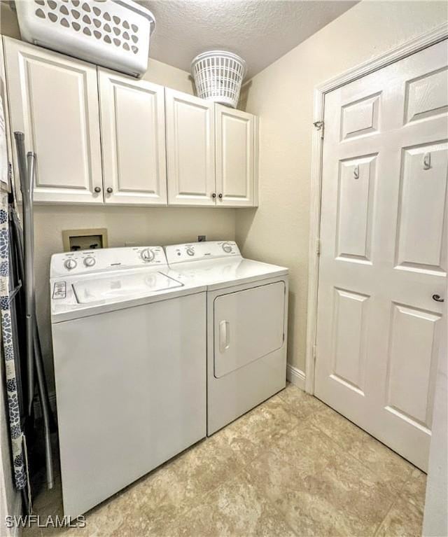 7066 Barrington Cir Unit 201, Naples, FL 34108 - laundry area featuring separate washer and dryer, cabinet space, and a textured ceiling