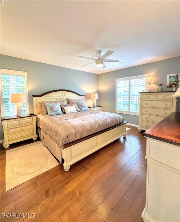 7066 Barrington Cir Unit 201, Naples, FL 34108 - bedroom with dark wood-type flooring and a ceiling fan
