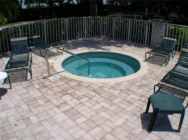 7066 Barrington Cir Unit 201, Naples, FL 34108 - view of pool featuring a community hot tub and a patio