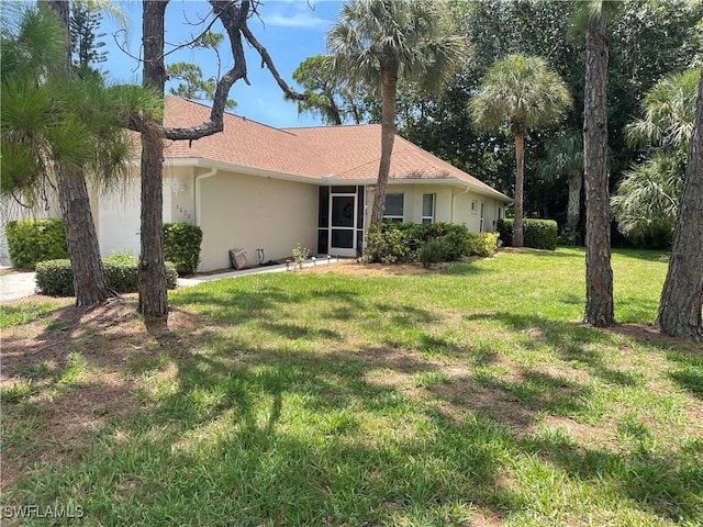 3620 Stone Way, Estero, FL 33928 - view of front of home featuring stucco siding, a front yard, and an attached garage