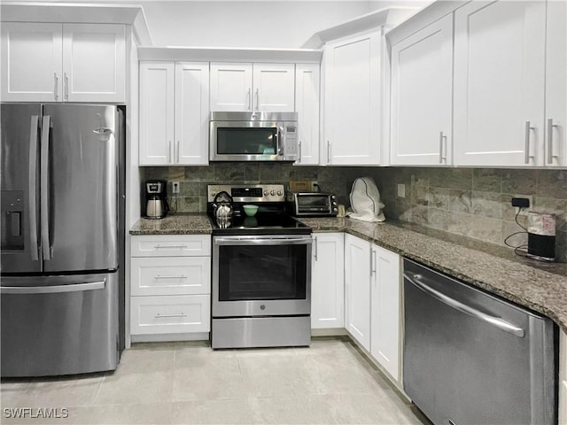 3620 Stone Way, Estero, FL 33928 - kitchen featuring stainless steel appliances, dark stone counters, white cabinets, and backsplash