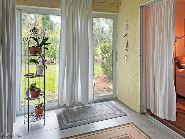 3620 Stone Way, Estero, FL 33928 - doorway to outside with a textured wall and healthy amount of natural light